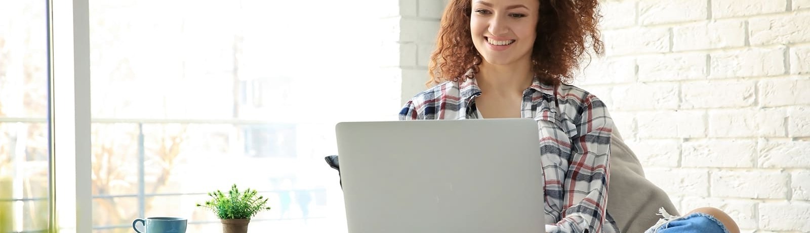 woman sitting in a chair working on a laptop