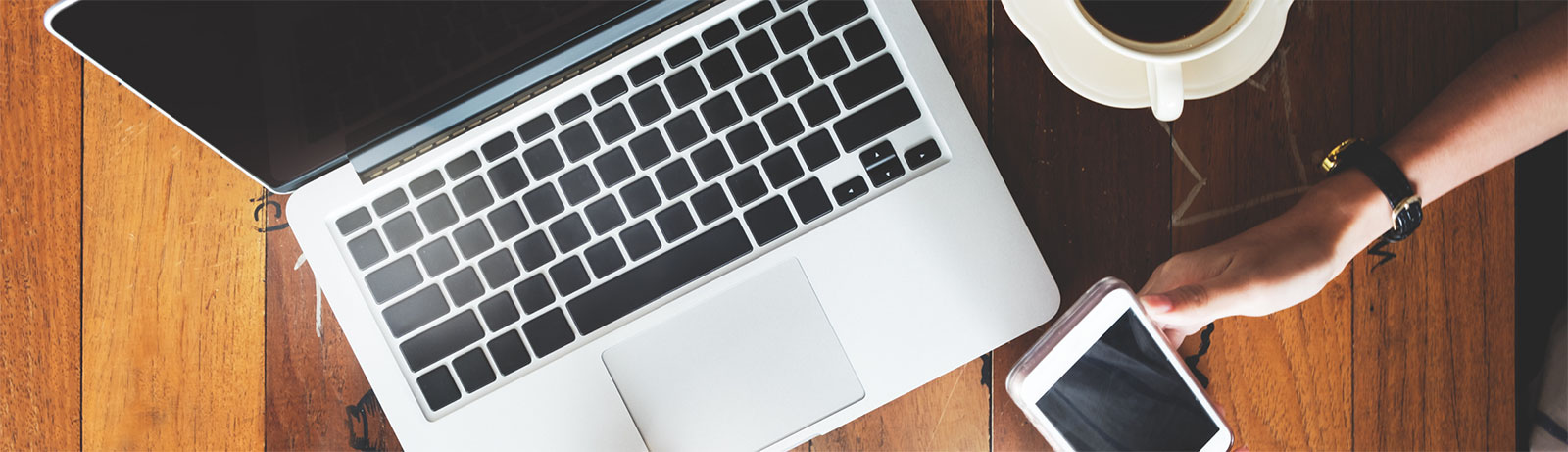Overhead shot of person using phone and laptop