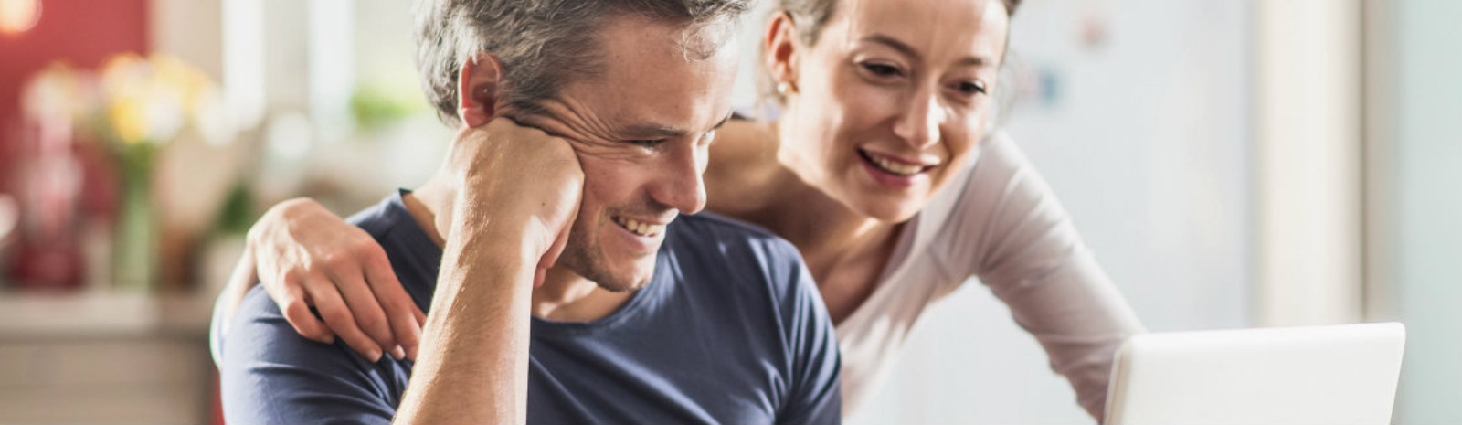 husband and wife viewing a laptop