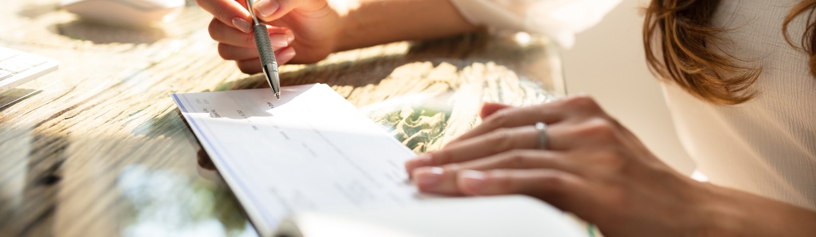 a person writing a business check