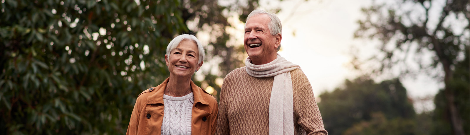 Mature couple walking and smiling outdoors