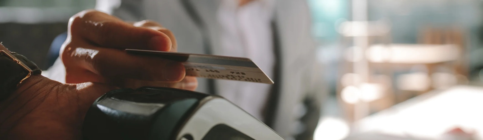 a person making a credit debit card purchase