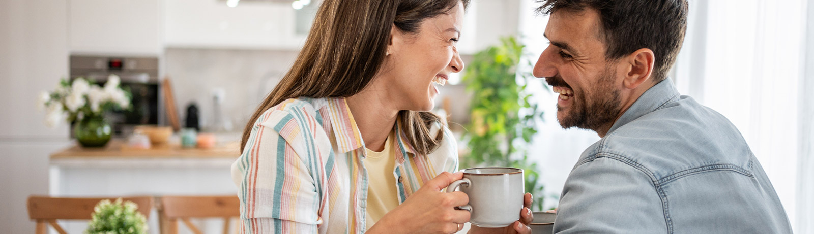 Young couple smiling in kitchen