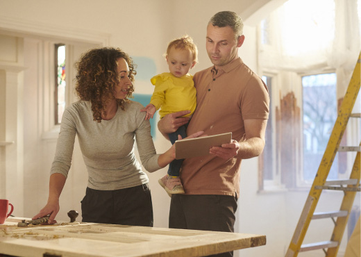 Young family working on renovation plans in home